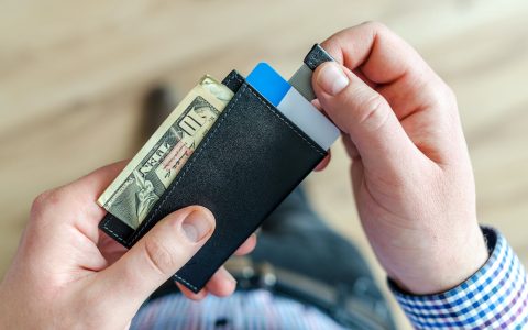 person holding black card holder